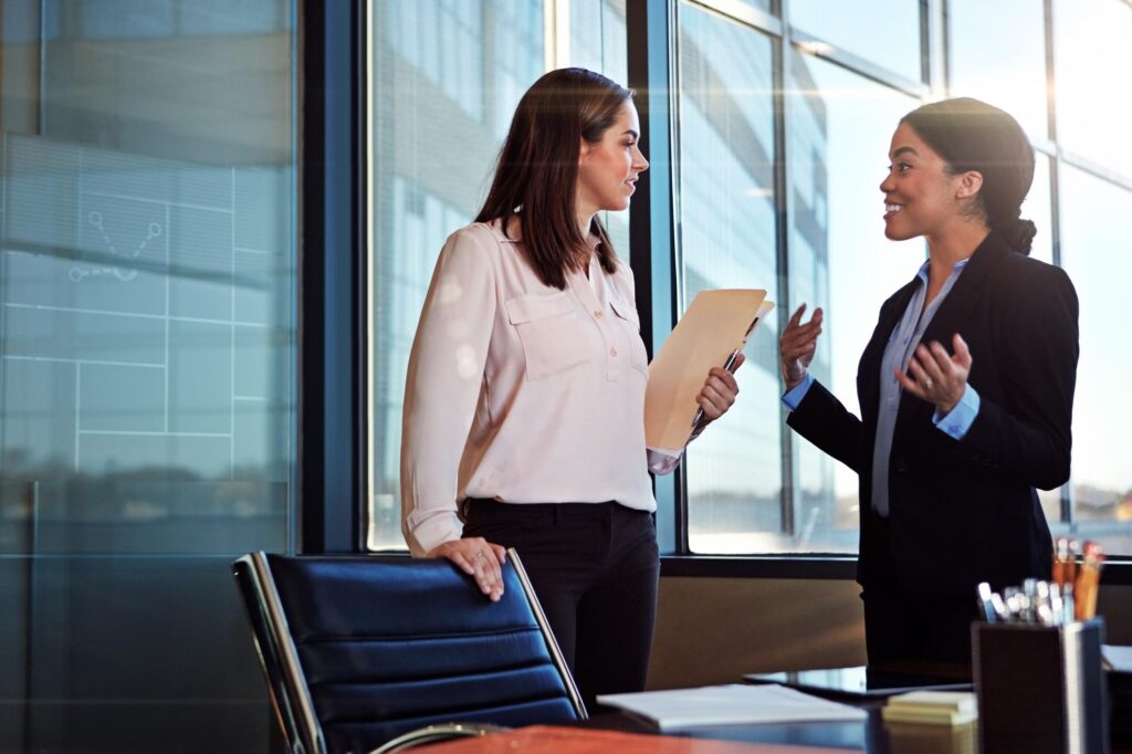 two young lawyers having a conversation in their office