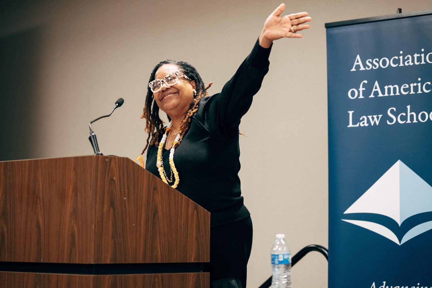Danielle M. Conway waving at a podium
